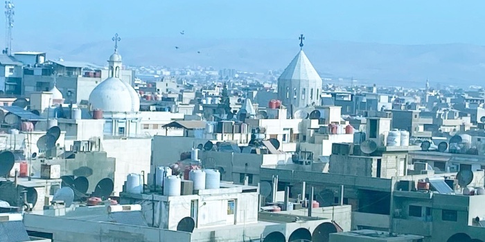 Qamişlo sabahında perdeleri açınca, karşımda görebildiğim ilk şey savaş yorgunu binalar arasındaki dini mabetlerin göstergeleri oluyor. Bunlar içerisinden iki kilisenin yükselen minarelerinin tepesindeki haç dikkat çekici. Bu Rojava kentinde, ilk göze çarpan iki kilise kulesi… Fotoğrafını çekip Türkiye’deki Hristiyan bir arkadaşıma gönderiyorum...